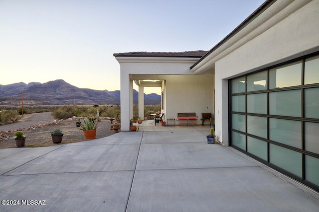 patio terrace at dusk with a mountain view