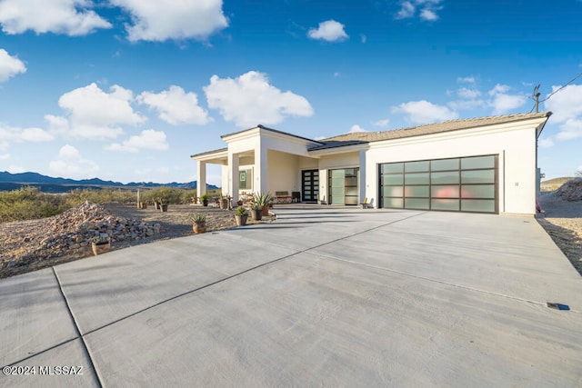 contemporary house with a mountain view and a garage