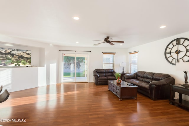 living room featuring dark hardwood / wood-style floors and ceiling fan