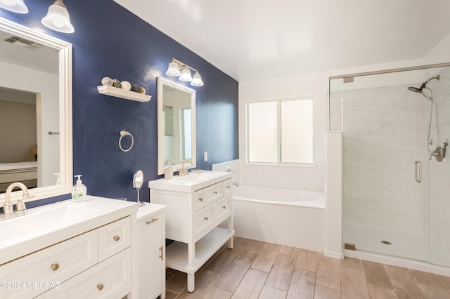 bathroom with vanity and plus walk in shower