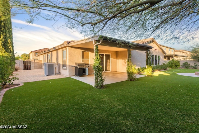 back of house featuring a patio, central AC unit, and a yard