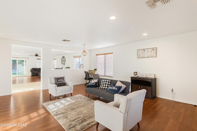 living room with light wood-type flooring and ceiling fan