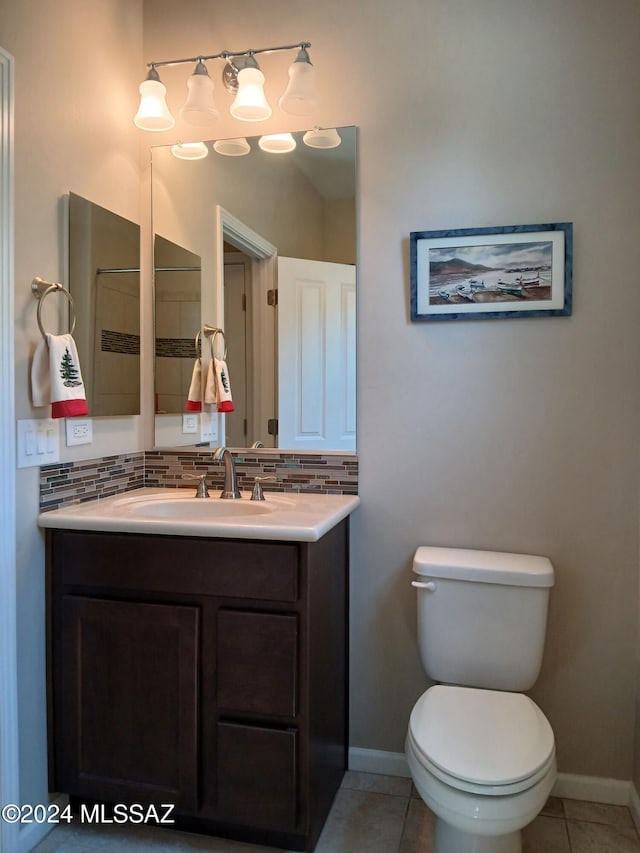 bathroom with vanity, tasteful backsplash, toilet, and tile patterned floors