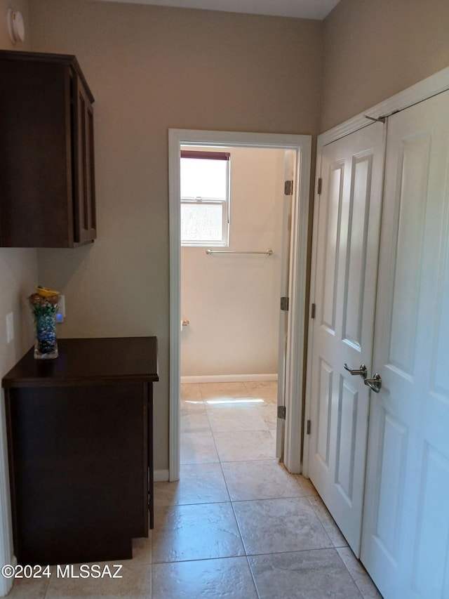 hall featuring light tile patterned flooring