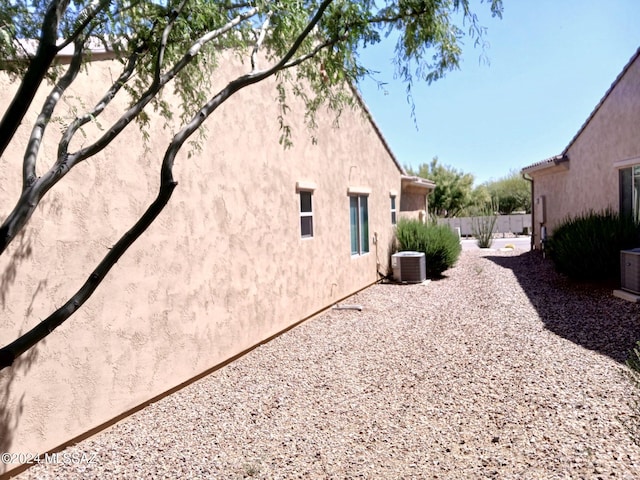 view of property exterior with a patio and cooling unit