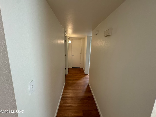 corridor with wood-type flooring