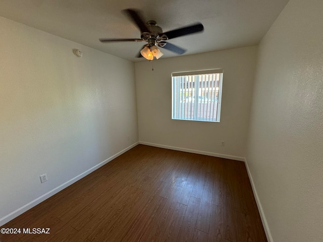 spare room featuring ceiling fan and dark hardwood / wood-style floors