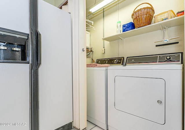 washroom with light tile patterned flooring and washing machine and dryer