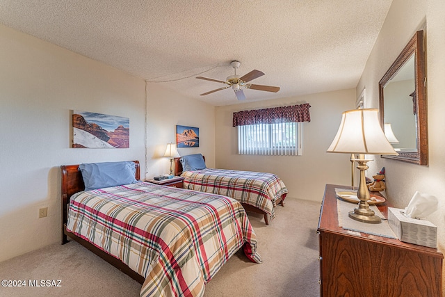 bedroom featuring carpet flooring, ceiling fan, and a textured ceiling