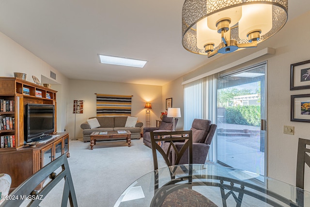 living room with carpet and an inviting chandelier