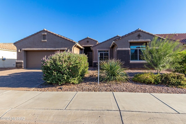 8869 W Irongate Rd, Marana, AZ 85653 - view of front of house with stucco siding, decorative driveway, a garage, and a tiled roof
