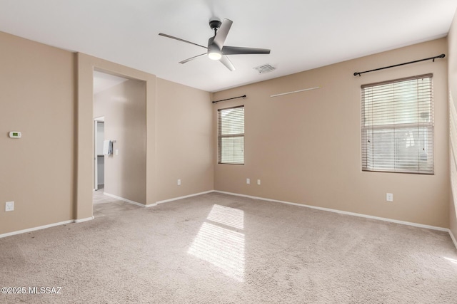 carpeted spare room with ceiling fan