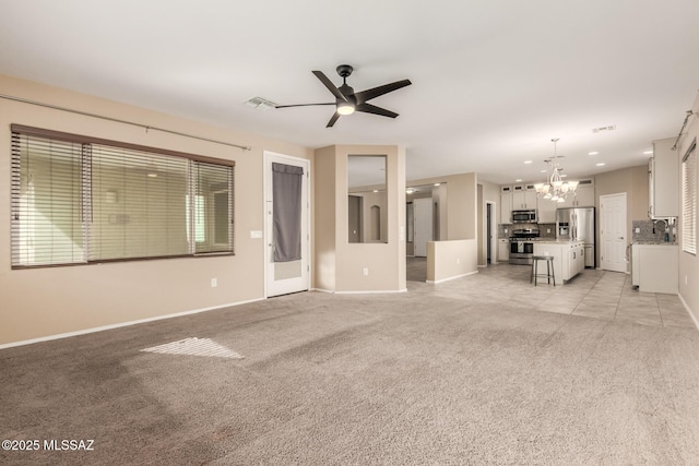 8869 W Irongate Rd, Marana, AZ 85653 - unfurnished living room featuring a chandelier, light colored carpet, baseboards, a ceiling fan, and a sink