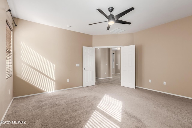 unfurnished bedroom with ceiling fan and light colored carpet