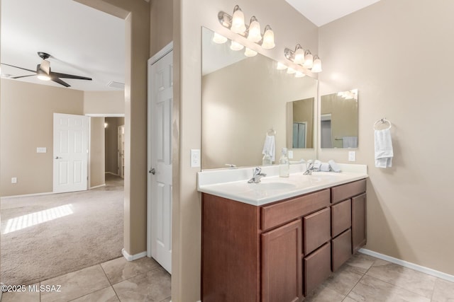 bathroom with tile patterned flooring, vanity, and ceiling fan