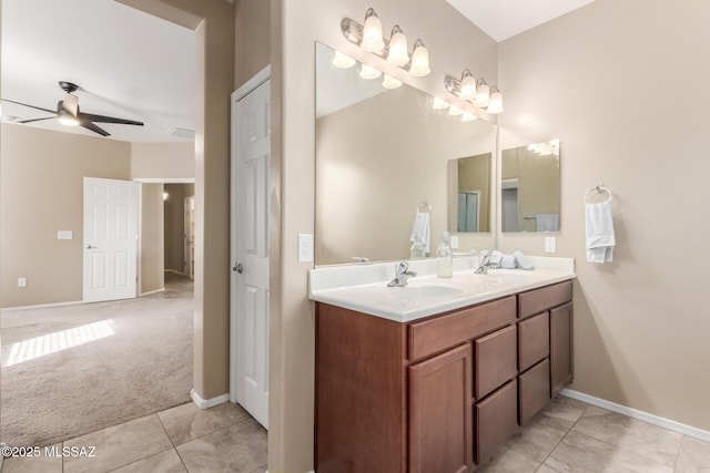8869 W Irongate Rd, Marana, AZ 85653 - full bath featuring ceiling fan, double vanity, tile patterned flooring, and baseboards