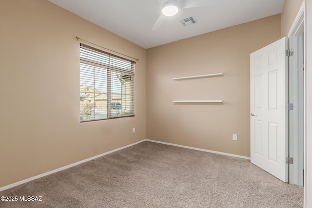 unfurnished room featuring light carpet and ceiling fan