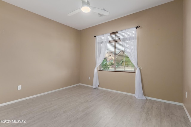 spare room with ceiling fan and light hardwood / wood-style flooring