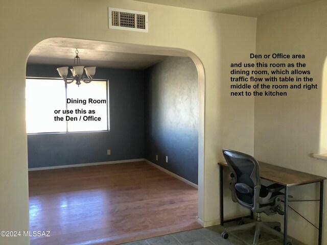 unfurnished office with wood-type flooring and an inviting chandelier