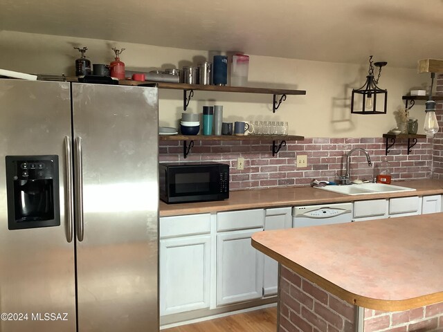 kitchen featuring dishwasher, light hardwood / wood-style flooring, stainless steel refrigerator with ice dispenser, sink, and white cabinets