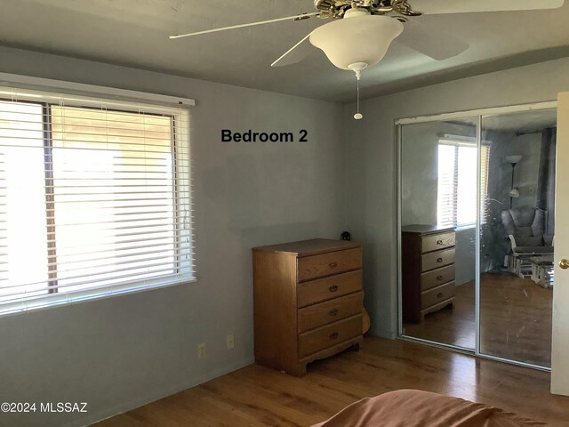 unfurnished bedroom featuring a closet, dark wood-type flooring, and ceiling fan