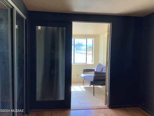 hallway with hardwood / wood-style floors