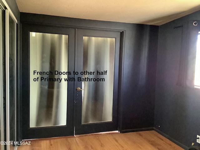 7857 W Winchester Easement, Willcox, AZ 85643 - doorway to outside with light wood-style floors, baseboards, and french doors