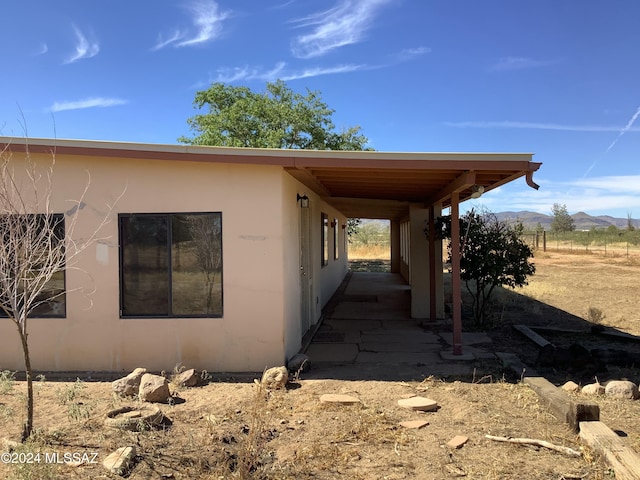 view of side of home featuring a mountain view