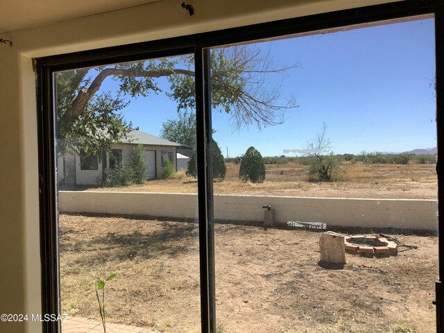 exterior space featuring a rural view and a fire pit