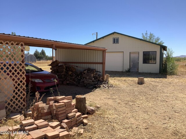 view of side of property featuring a garage and an outdoor structure