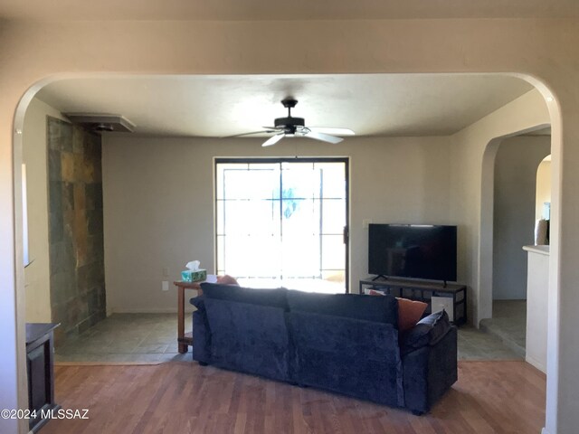 living room with ceiling fan and hardwood / wood-style floors