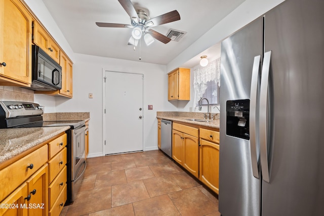 kitchen featuring stainless steel appliances, sink, ceiling fan, light stone counters, and light tile patterned floors