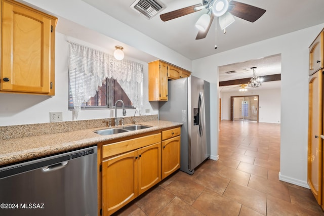 kitchen with appliances with stainless steel finishes, ceiling fan, pendant lighting, dark tile patterned floors, and sink