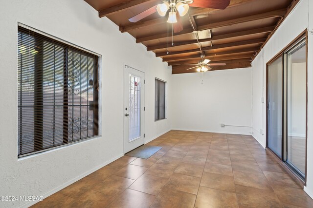 interior space with ceiling fan, lofted ceiling with beams, and wooden ceiling