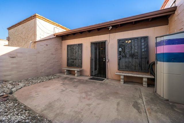 property entrance featuring a patio area