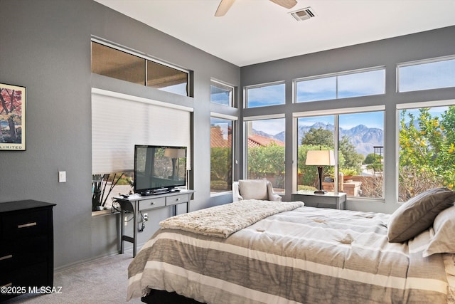 carpeted bedroom featuring baseboards, visible vents, and a ceiling fan