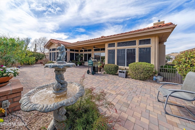 view of patio with fence, a ceiling fan, and area for grilling