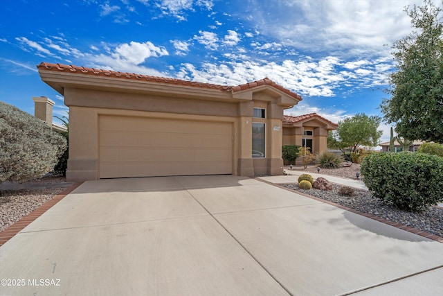 mediterranean / spanish-style house featuring a garage, driveway, a tile roof, and stucco siding