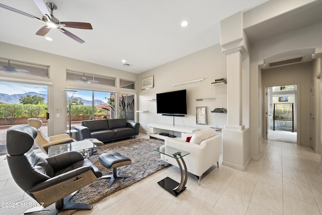 living room with baseboards, recessed lighting, a ceiling fan, and ornate columns