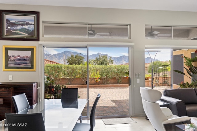 interior space with a mountain view and ceiling fan