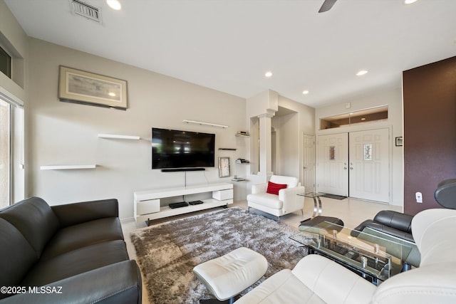 living area with visible vents, decorative columns, and recessed lighting