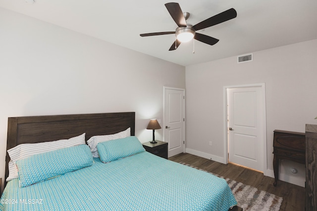 bedroom featuring ceiling fan and dark wood-type flooring