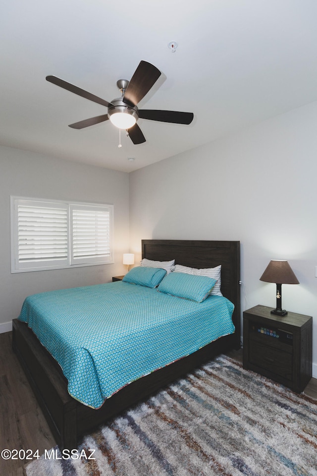 bedroom with ceiling fan and dark wood-type flooring