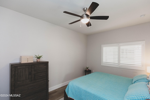 bedroom with ceiling fan and dark hardwood / wood-style floors