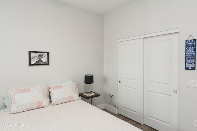 bedroom featuring dark hardwood / wood-style flooring and a closet