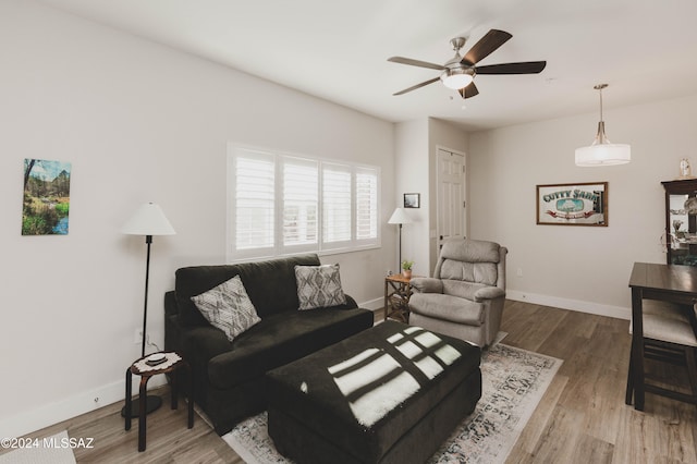 living room with hardwood / wood-style flooring and ceiling fan