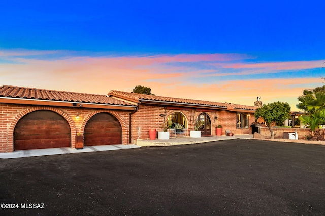 mediterranean / spanish house featuring a garage