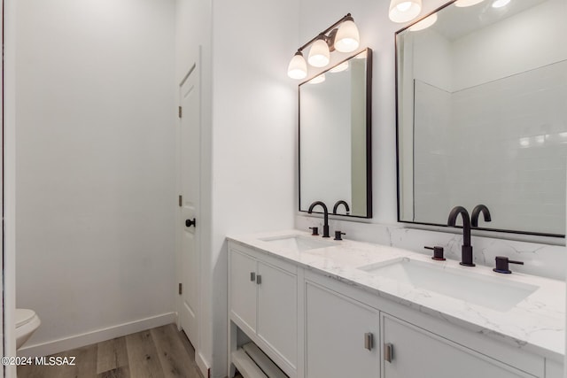 bathroom featuring vanity, toilet, and hardwood / wood-style floors