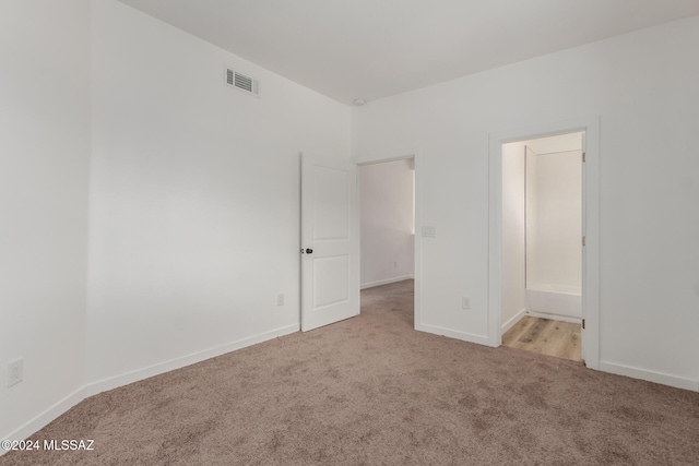 unfurnished room with light carpet