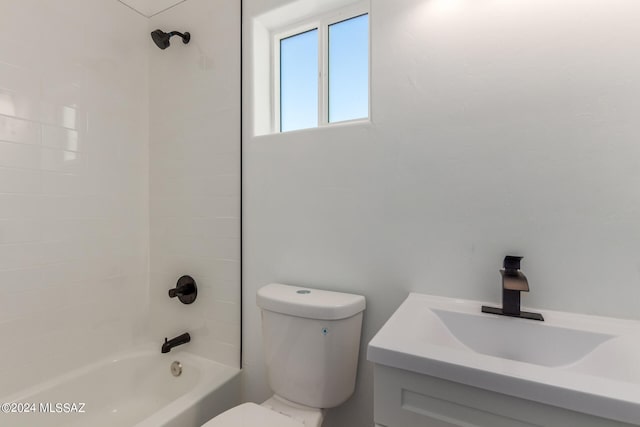 full bathroom featuring vanity, tiled shower / bath combo, and toilet